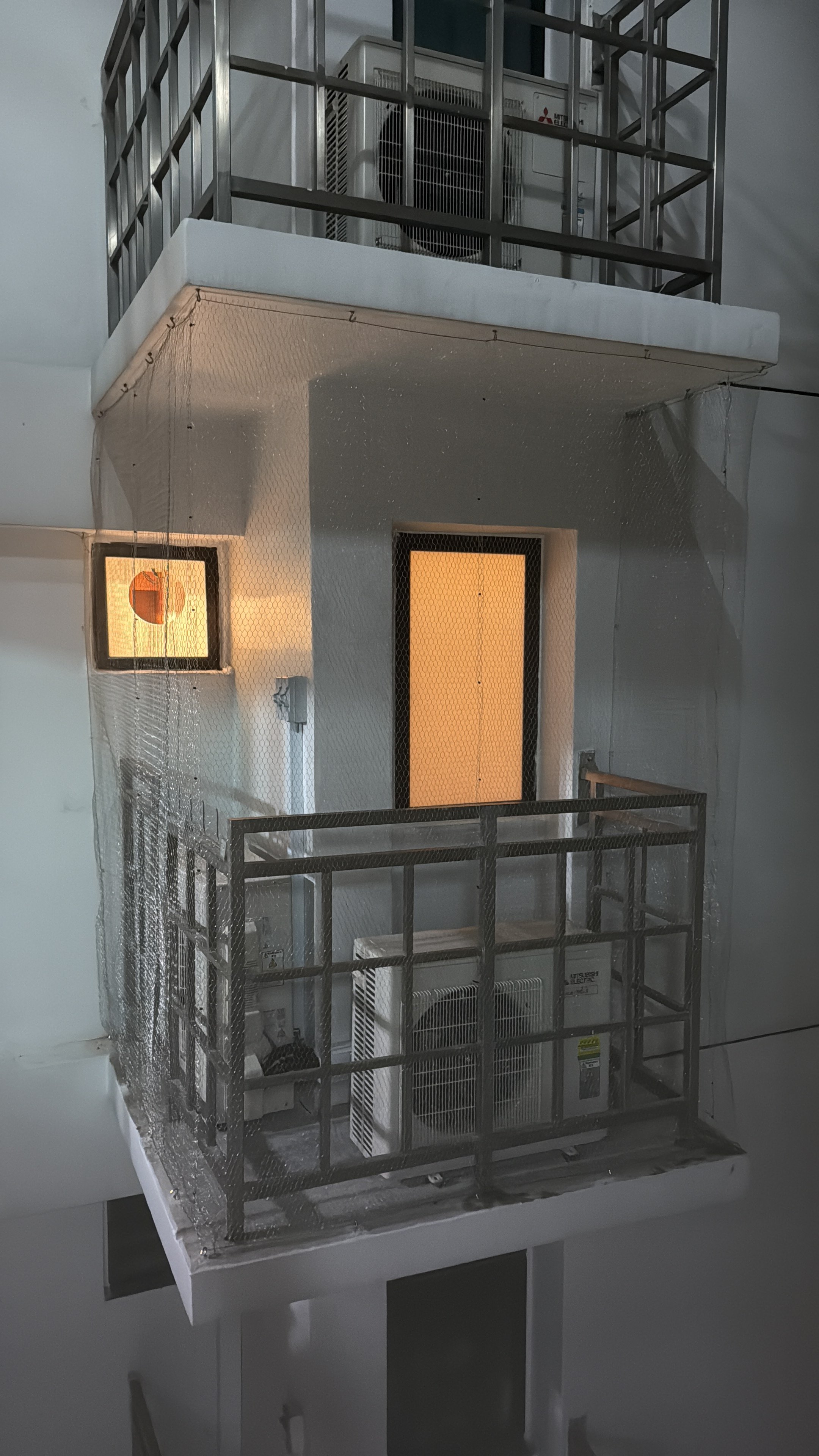 Stainless steel mesh installed on HDB aircon ledge in Singapore by Coogle Aircon — rigid diamond-pattern SS mesh covering outdoor condenser unit