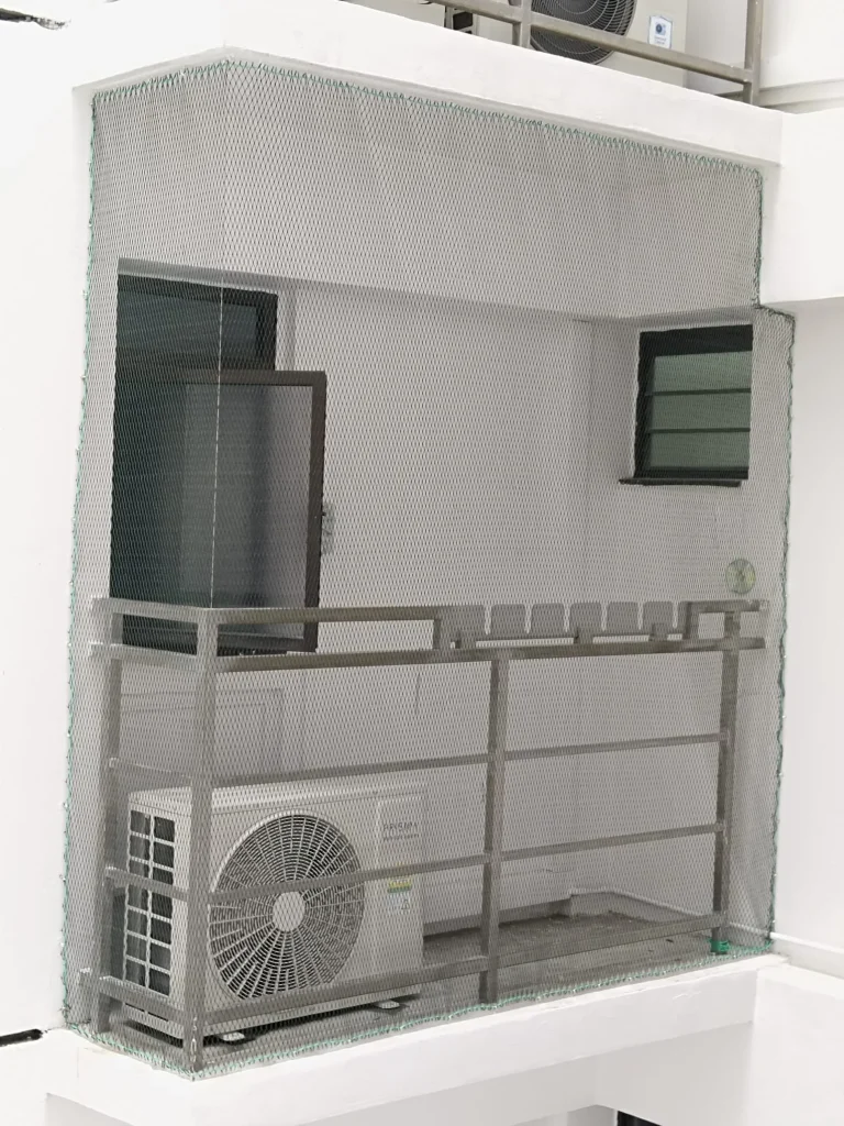 Professionally installed compliant bird netting on HDB aircon ledge in Singapore — legal, no HDB approval required for standard installations